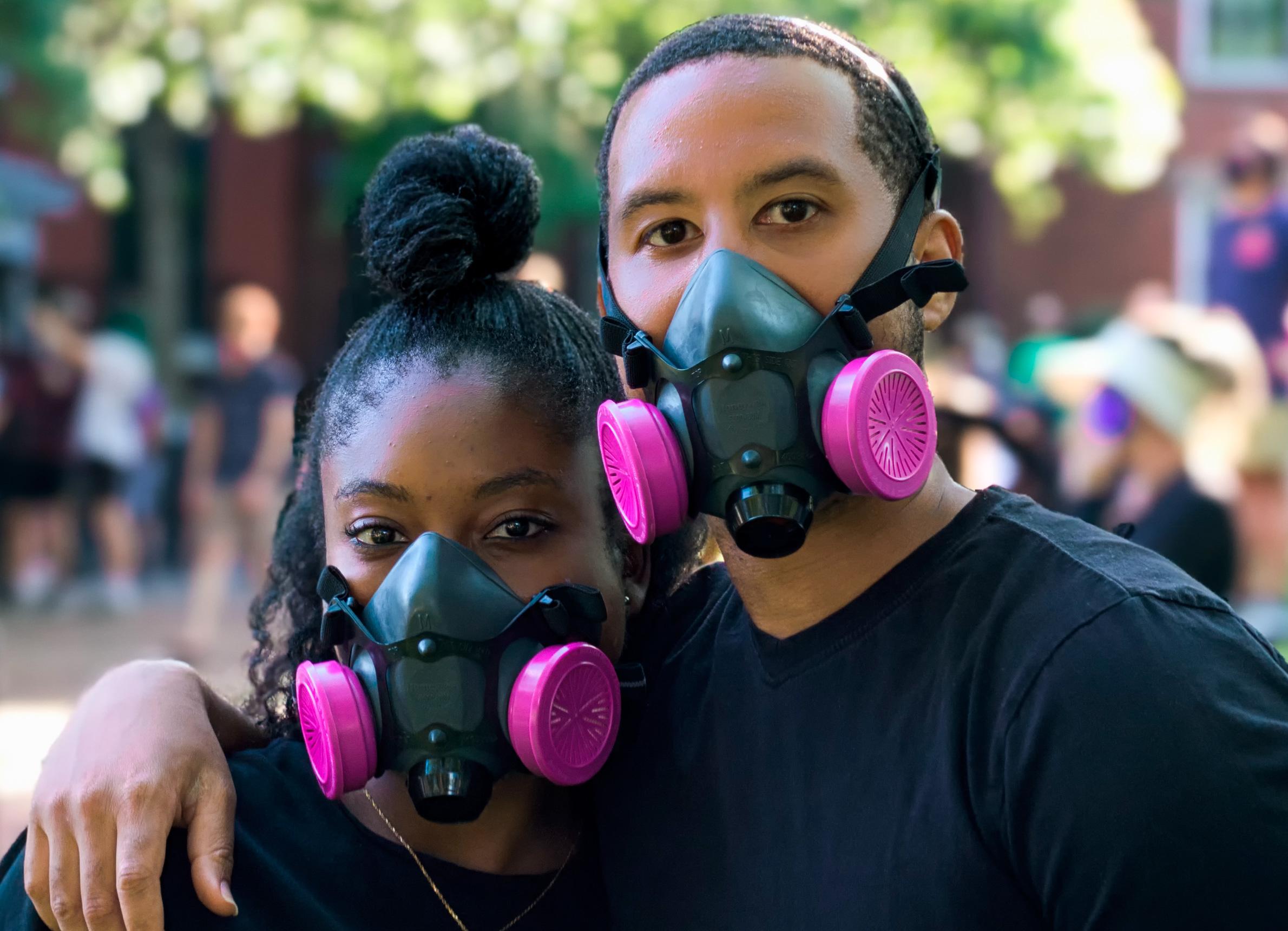 Image of Black people wearing masks and looking into the camera